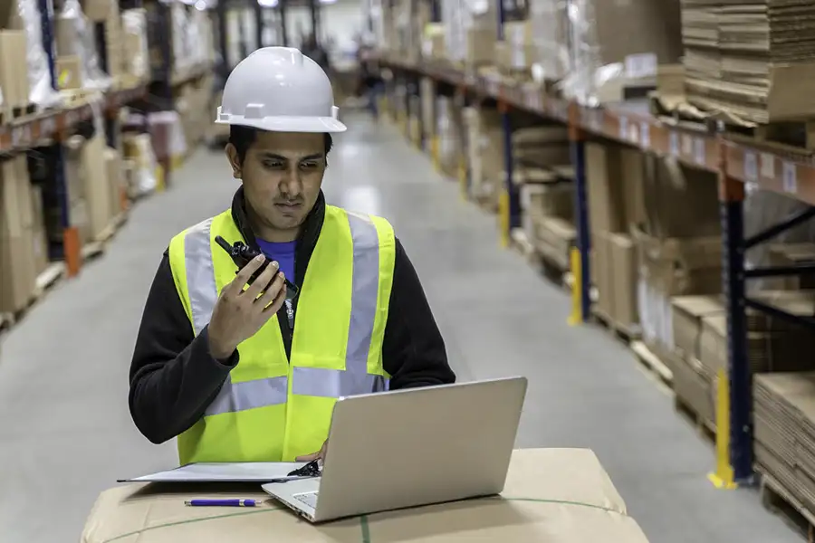 Warehouse worker talking on Motorola radio